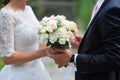 Groom gives the bride close-up beautiful wedding bouquet. For walk in the park Royalty Free Stock Photo