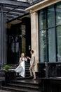 The groom gives his hand to the bride walking down the stairs. Shooting on the wedding day Royalty Free Stock Photo