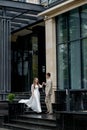 The groom gives his hand to the bride walking down the stairs. Shooting on the wedding day Royalty Free Stock Photo