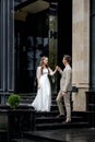 The groom gives his hand to the bride walking down the stairs. Shooting on the wedding day Royalty Free Stock Photo