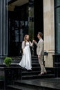 The groom gives his hand to the bride walking down the stairs. Shooting on the wedding day Royalty Free Stock Photo