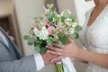 Groom giving elegant wedding bouquet to his bride. Beautiful wedding bouquet