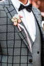 Groom in gray tuxedo and bowtie correct his buttons on white shirt. Wedding. Details Grooms morning preparation, Wedding concept Royalty Free Stock Photo