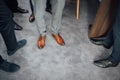 Groom and groomsmen men in blue suits standing in group with closeup of shoes and feet Royalty Free Stock Photo