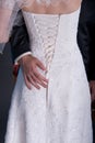 Groom hand on brides dress