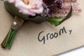 Groom hand written with wedding favour Royalty Free Stock Photo