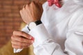 Groom hands fixing his cull links Royalty Free Stock Photo