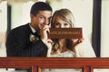 Groom has fun while siitting with a bride at the piano Royalty Free Stock Photo