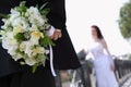 Groom hides bouquet for bride