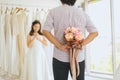 Groom hiding flower behind back in order to surprise bride,Woman positive emotion and face astonished happy and smling