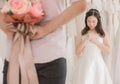 Groom hiding flower behind back in order to surprise bride,Woman positive emotion and face astonished,Romantic and sweet moment