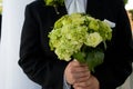 Groom holding bouquet Royalty Free Stock Photo