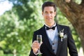 Groom holding champagne flute in garden Royalty Free Stock Photo