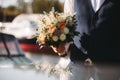 Groom holding in hands delicate, expensive, trendy bridal wedding bouquet of flowers Royalty Free Stock Photo