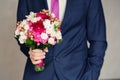 Groom holding wedding bouquet