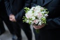 Groom holding a wedding bouquet Royalty Free Stock Photo