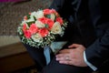 Groom holding wedding bouquet of white roses . bridal bouquet bride and groom on the Azerbaijan wedding . holding a beautiful