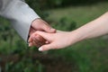 Groom holds the bride by the hand closeup Royalty Free Stock Photo