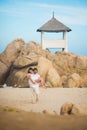 Groom holds the bride in his arms against a rocky terrain Royalty Free Stock Photo