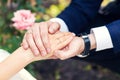 Groom holds the bride's hand