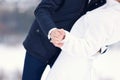 Groom holds the bride's hand