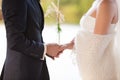 Groom holds the bride's hand