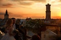 Groom holds bride's waist standing on the roof and wathcing a su Royalty Free Stock Photo