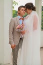 Groom hug and kiss bride in palm grove. Wedding day for two. Lovely weeding couple. Young lovers Royalty Free Stock Photo