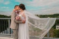 Groom hug and kiss bride in palm grove. Wedding day for two. Lovely weeding couple. Young lovers Royalty Free Stock Photo