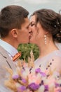 Groom hug and kiss bride in palm grove. Wedding day for two. Lovely weeding couple. Young lovers Royalty Free Stock Photo