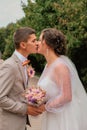 Groom hug and kiss bride in palm grove. Wedding day for two. Lovely weeding couple. Young lovers Royalty Free Stock Photo