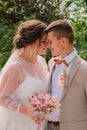 Groom hug and kiss bride in palm grove. Wedding day for two. Lovely weeding couple. Young lovers Royalty Free Stock Photo