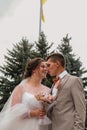 Groom hug and kiss bride in palm grove. Wedding day for two. Lovely weeding couple. Young lovers Royalty Free Stock Photo