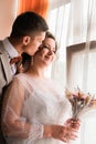 Groom hug and kiss bride in palm grove. Wedding day for two. Lovely weeding couple. Young lovers Royalty Free Stock Photo