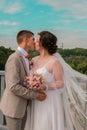 Groom hug and kiss bride in palm grove. Wedding day for two. Lovely weeding couple. Young lovers Royalty Free Stock Photo