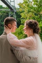 Groom hug and kiss bride in palm grove. Wedding day for two. Lovely weeding couple. Young lovers Royalty Free Stock Photo