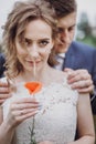 Groom  hugging beautiful gorgeous bride with poppy flower. happy sensual wedding couple embracing in love, at old castle. happy Royalty Free Stock Photo