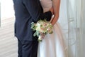 The groom hugs the bride, the bride holds a beautiful wedding bouquet Royalty Free Stock Photo