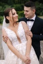 Groom hugs his bride from behind and kiss. Happy newlyweds Royalty Free Stock Photo