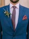 Groom in a jacket with a boutonniere on the lapel and a handkerchief in his pocket. Close-up