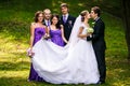 Groom kisses a bride while his friends grimaces behind him Royalty Free Stock Photo