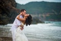 Groom kisses the bride at the sea. couple in love on a deserted beach