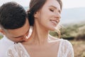 The groom kisses the bride on the shoulder. Sensual portrait of young elegant just married pair Royalty Free Stock Photo