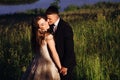 Groom kisses bride tender while she stands smiling Royalty Free Stock Photo