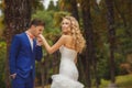 The groom kisses the hand of the bride in green Park. Royalty Free Stock Photo