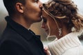 Groom kissing beautiful bride in forehead. Autumn wedding. Royalty Free Stock Photo