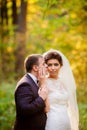 The groom is kissing the bride in autumn forest Royalty Free Stock Photo