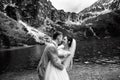 The groom kissing his young bride, on the shore of the lake Morskie Oko. Poland. Black and white photo Royalty Free Stock Photo