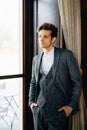 Groom leaned against the frame of the large window of the old villa. Lake Como Royalty Free Stock Photo