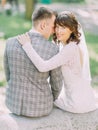 The groom is leaning on the shoulde of the smiling bride. The back view. Royalty Free Stock Photo